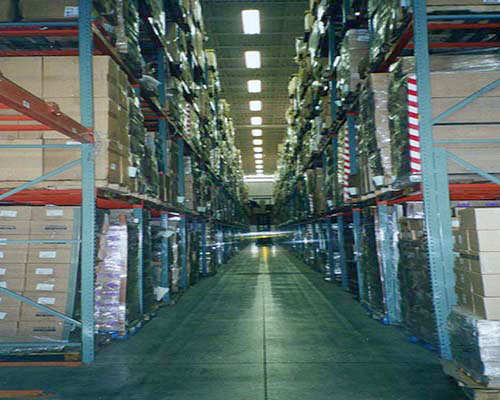 interior warehouse image down a row with tall shelving